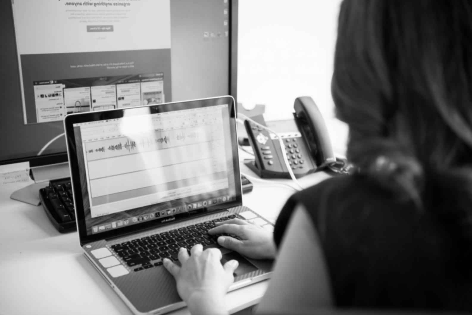 Students collaborating in virtual study environment with laptops and financial documents spread across desks